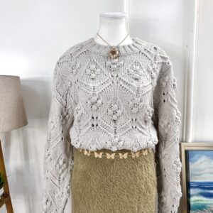 Cable knit sweater with pom pom